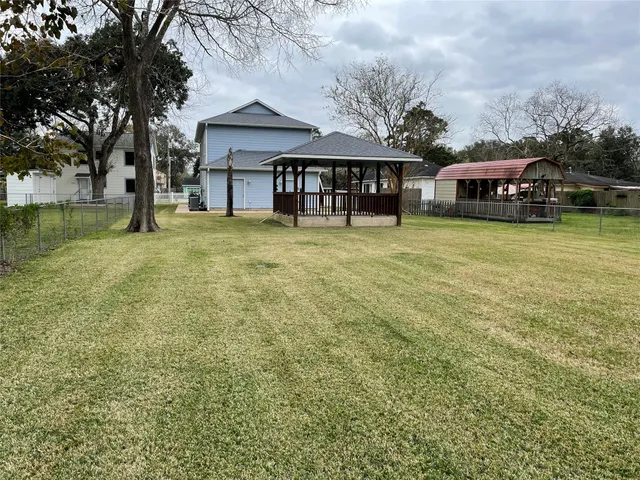 a front view of a house with a garden and trees
