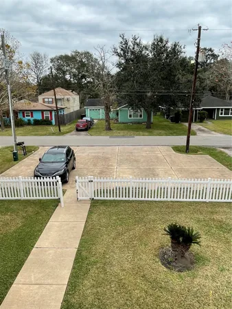 a view of a park with iron fence