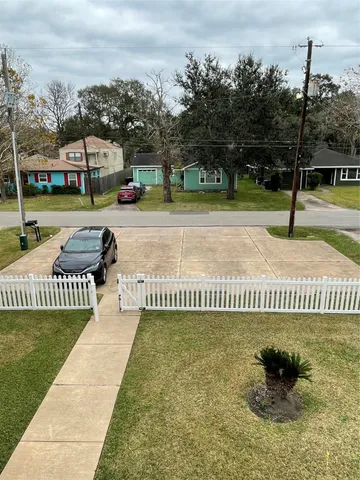 a view of a park with iron fence