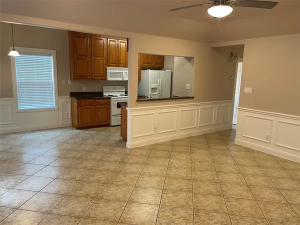 a kitchen with a sink a stove and cabinets
