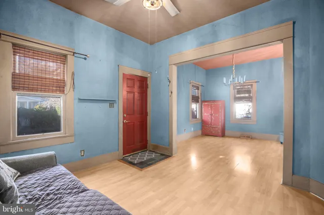 a view of a bedroom with wooden floor and windows
