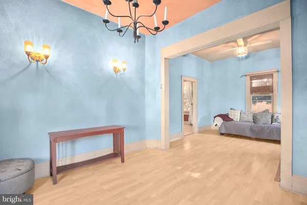 a view of a bedroom with a large bed and dresser