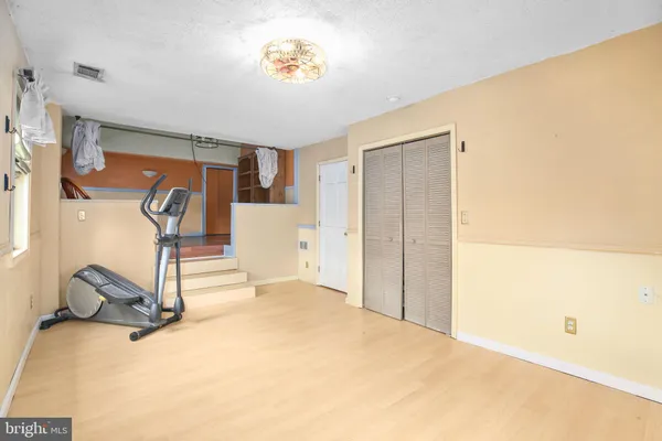 a view of a dining room with furniture a chandelier and wooden floor