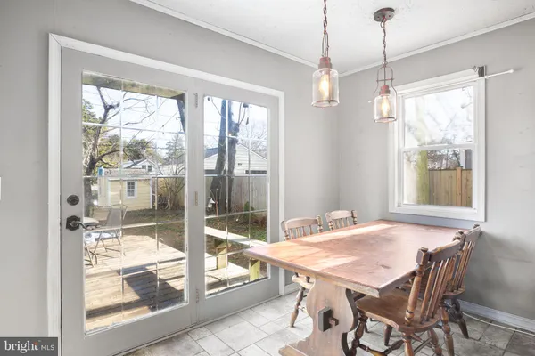 a view of a dining room with furniture large windows and wooden floor