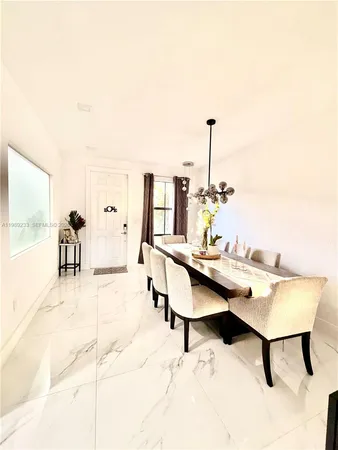 a living room with furniture and view of kitchen