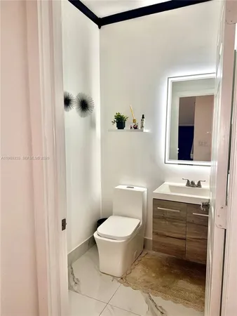 a bathroom with a toilet a sink and mirror