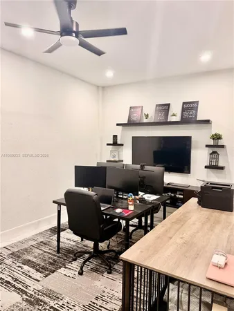 a livingroom with furniture and a flat screen tv