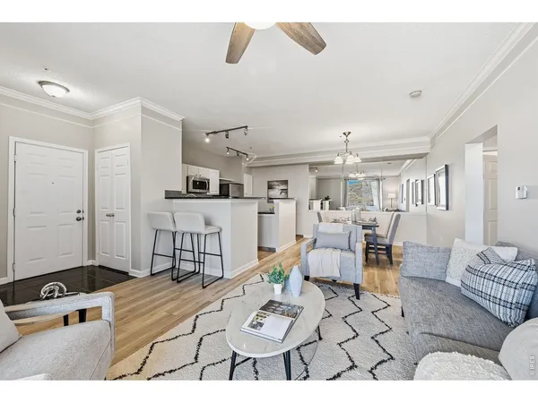 a living room with furniture and view of kitchen
