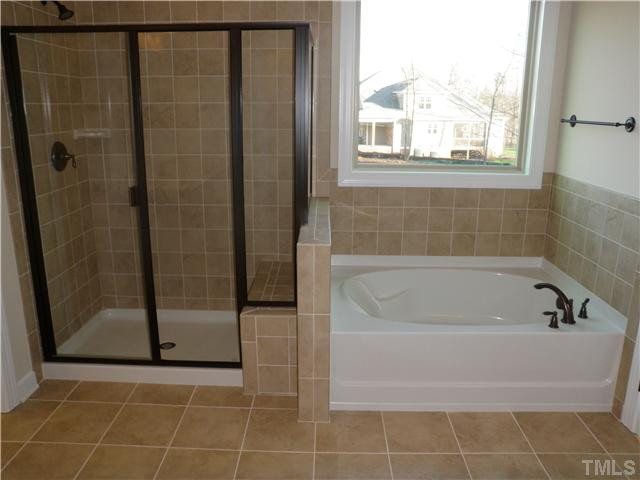 4854 Inwood Road Raleigh, NC 27603 - Photo 13 of 20 Seperate shower with tiled seat and garden tub with tile surround.