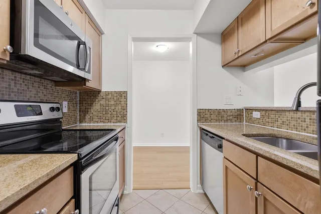 a kitchen with granite countertop a sink and a stove