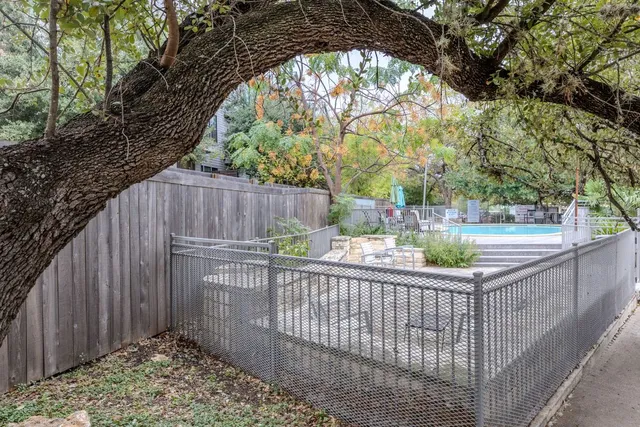 a view of a roof deck with wooden floor and fence