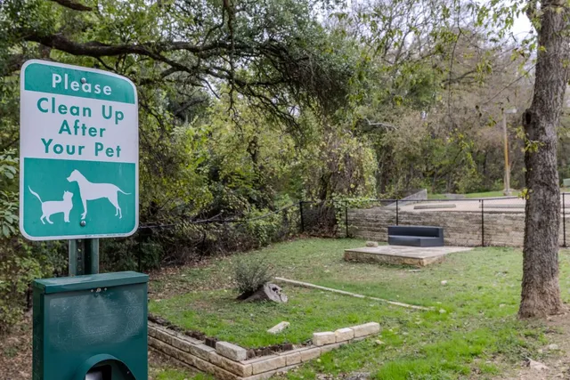 a view of a fence and a bench in the roof deck