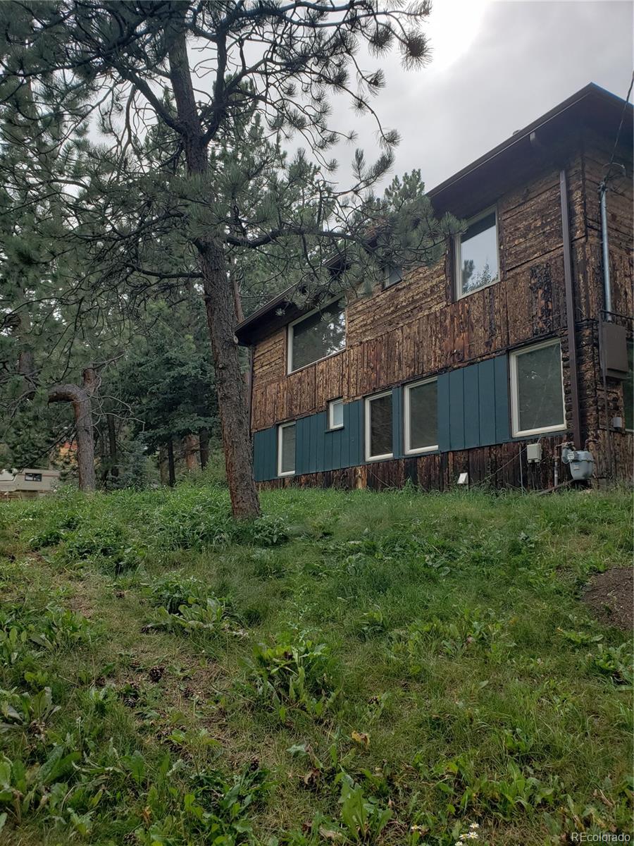 11769 Ranch Elsie Road Golden, CO 80403 - Photo 2 of 39 a view of a house with a yard