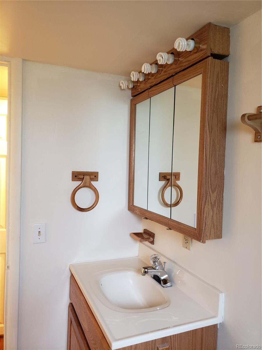 11769 Ranch Elsie Road Golden, CO 80403 - Photo 29 of 39 a bathroom with a sink and a mirror