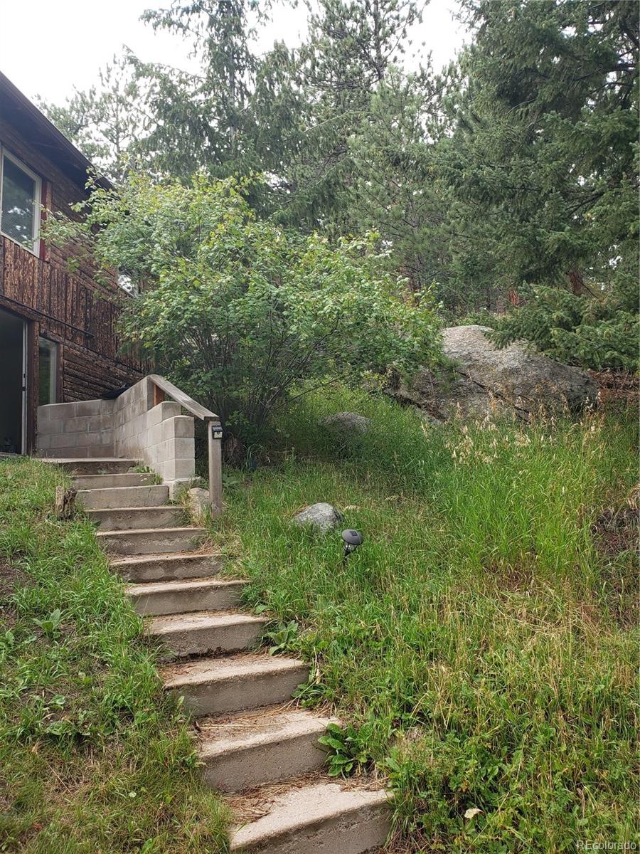 11769 Ranch Elsie Road Golden, CO 80403 - Photo 3 of 39 a view of a house with a yard