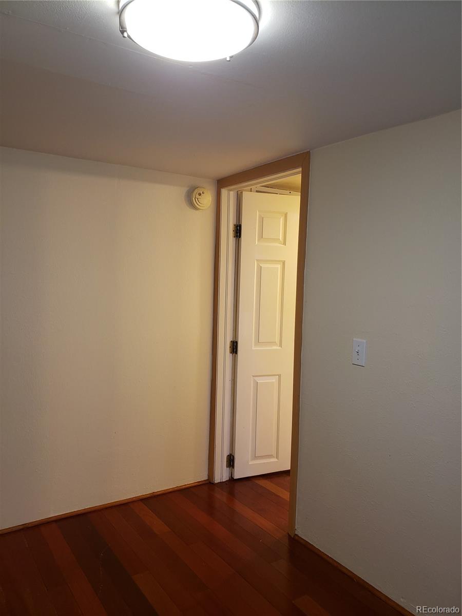 11769 Ranch Elsie Road Golden, CO 80403 - Photo 31 of 39 an empty room with wooden floor and windows