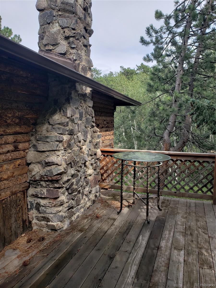 11769 Ranch Elsie Road Golden, CO 80403 - Photo 4 of 39 a view of balcony with wooden floor and outdoor seating