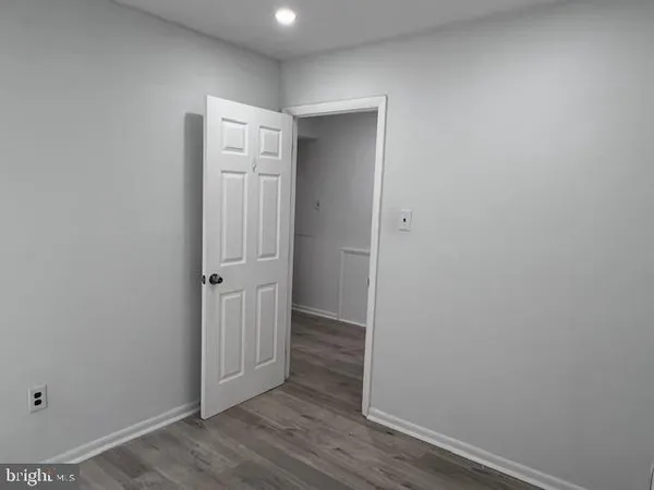 an empty room with wooden floor