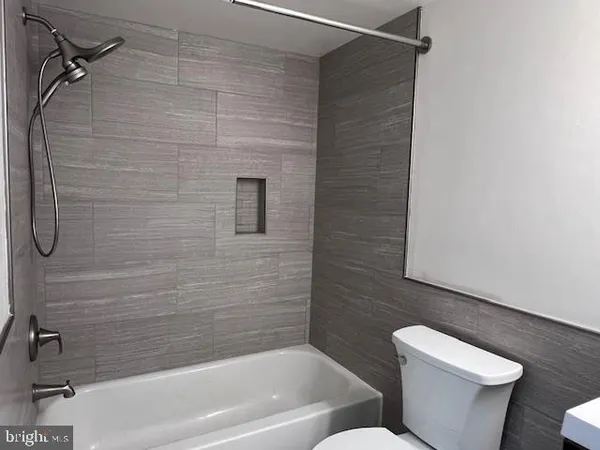 a bathroom with a toilet and a bathtub