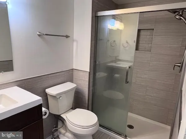 a white toilet sitting next to a bathroom sink