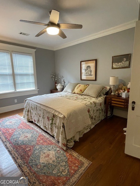 311 3rd Street Manchester, GA 31816 - Photo 28 of 61 a bedroom with a bed and a chandelier