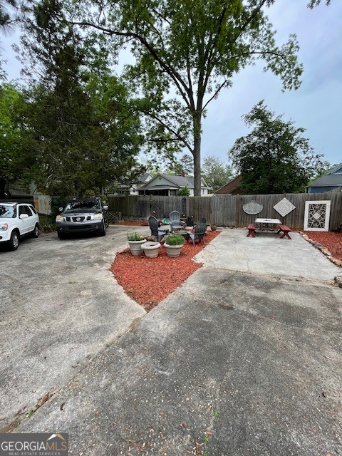 311 3rd Street Manchester, GA 31816 - Photo 53 of 61 a view of the patio with a bench and trees