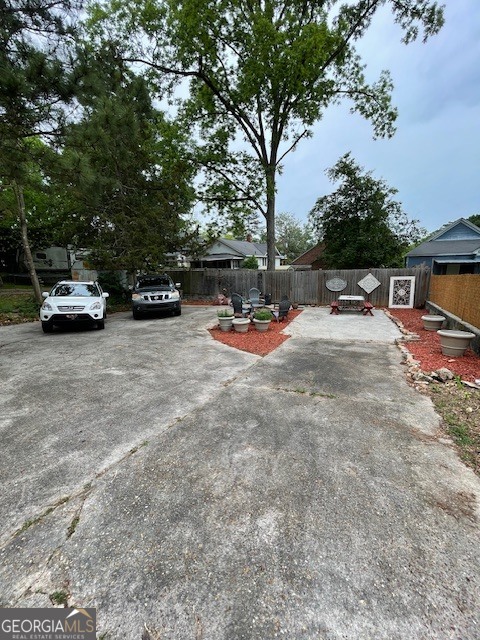 311 3rd Street Manchester, GA 31816 - Photo 54 of 61 a view of a backyard with table and chairs under an umbrella