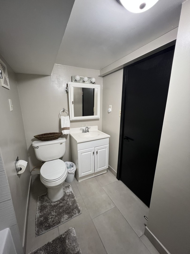 4818 North Moody Avenue, Unit G Chicago, IL 60630 - Photo 5 of 11 a white toilet sitting next to a bathroom sink