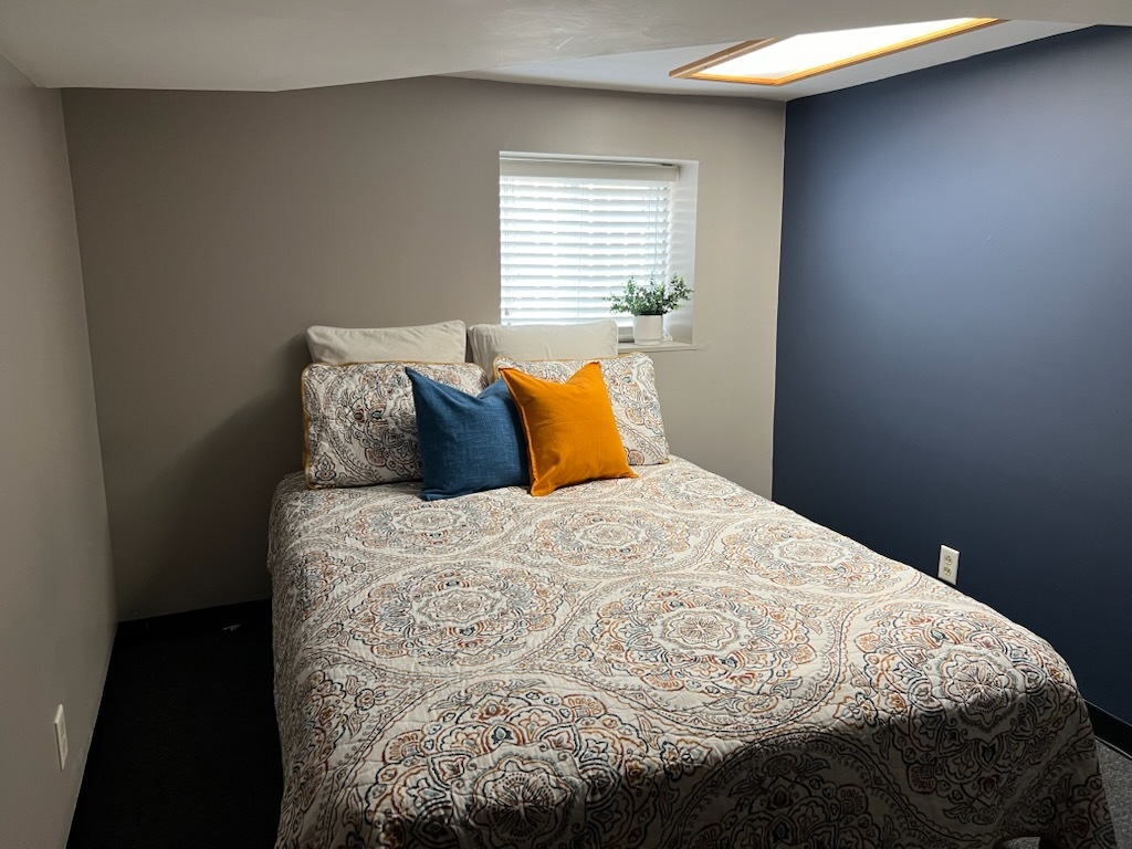 4818 North Moody Avenue, Unit G Chicago, IL 60630 - Photo 8 of 11 a bed sitting in a bedroom next to a window