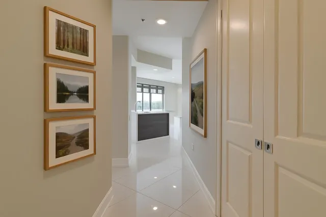 a hallway with windows and cabinet
