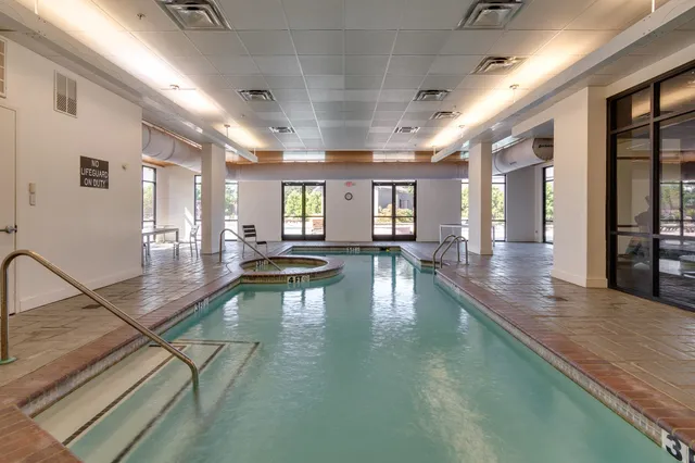 a room with gym equipment and floor to ceiling window