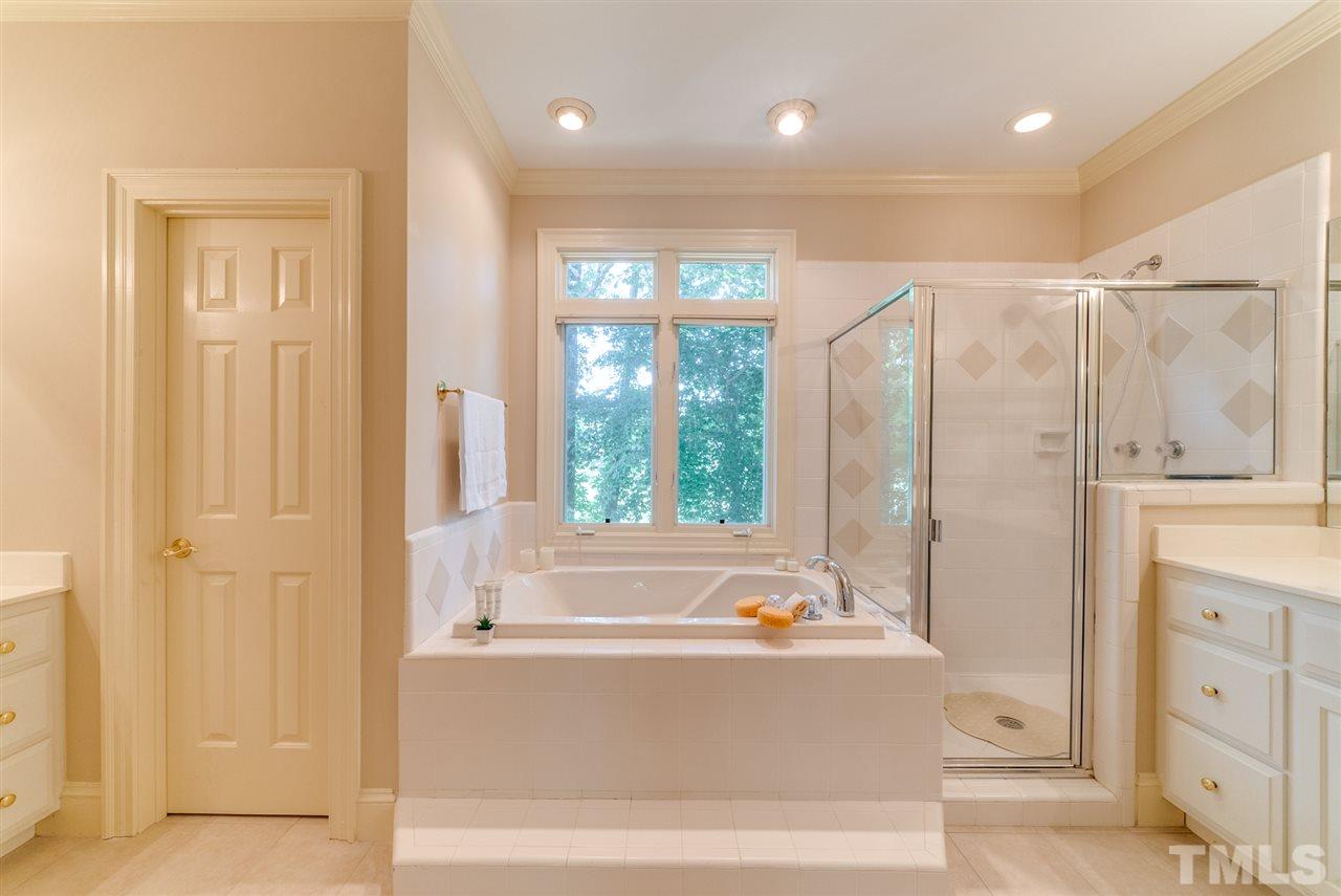 8912 Carnoustie Way Raleigh, NC 27613 - Photo 12 of 25 a bathroom with a bathtub and a shower
