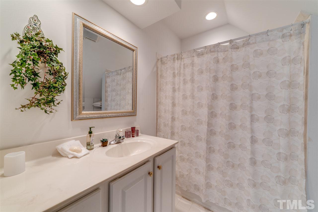 8912 Carnoustie Way Raleigh, NC 27613 - Photo 15 of 25 a bathroom with a sink and a mirror