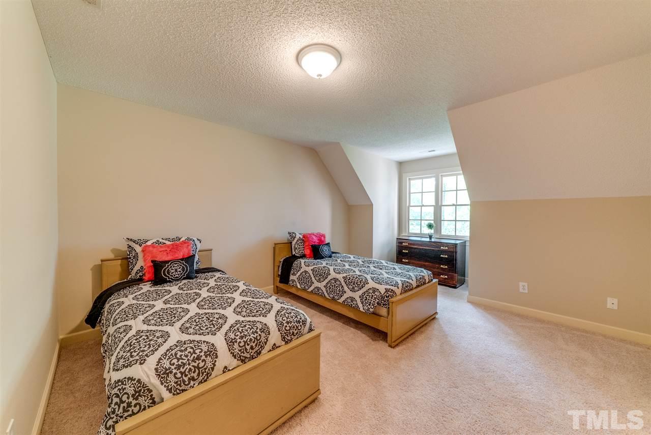8912 Carnoustie Way Raleigh, NC 27613 - Photo 16 of 25 a bedroom with two beds and a window