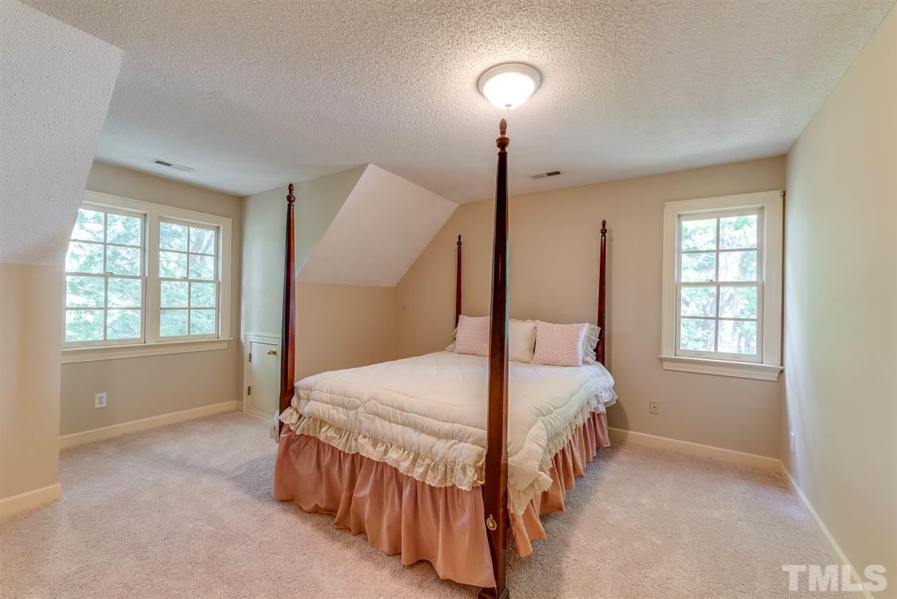 8912 Carnoustie Way Raleigh, NC 27613 - Photo 18 of 25 a bedroom with a bed and a window