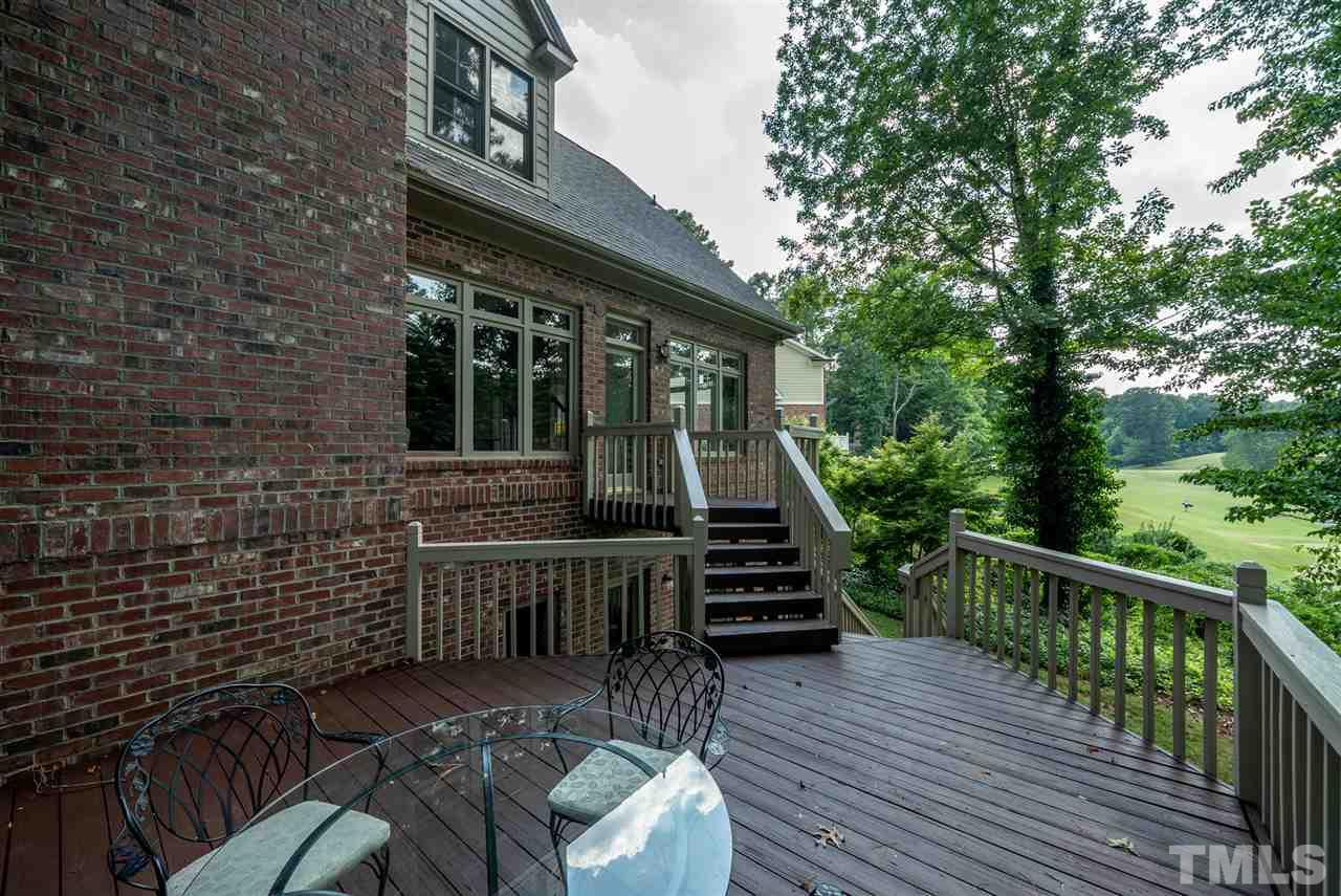 8912 Carnoustie Way Raleigh, NC 27613 - Photo 22 of 25 a view of a deck with chairs and wooden fence