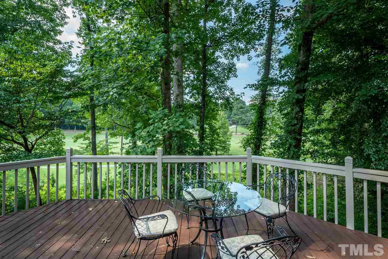 8912 Carnoustie Way Raleigh, NC 27613 - Photo 23 of 25 a view of a chair and table on the wooden floor