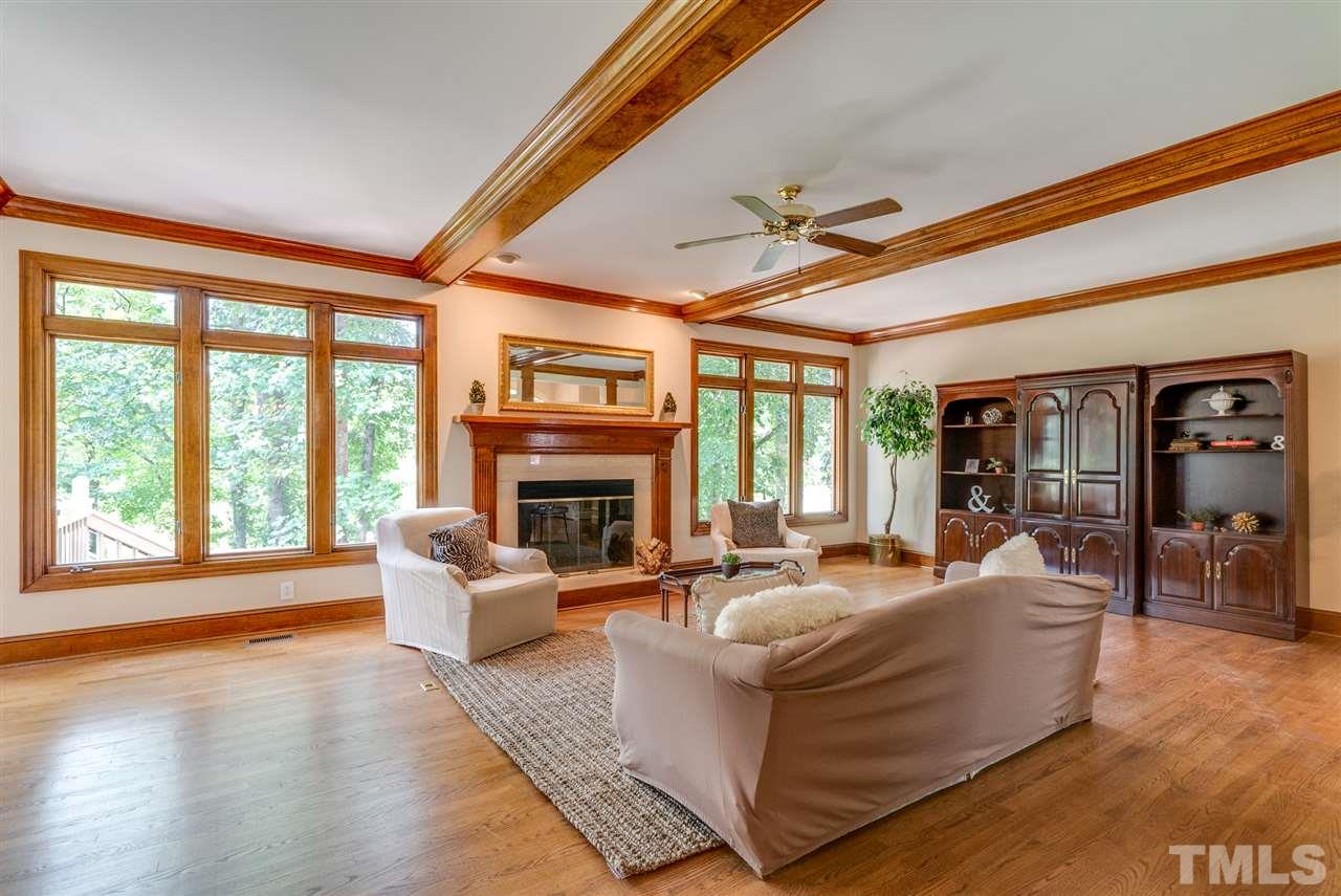 8912 Carnoustie Way Raleigh, NC 27613 - Photo 5 of 25 a living room with fireplace furniture and a large window