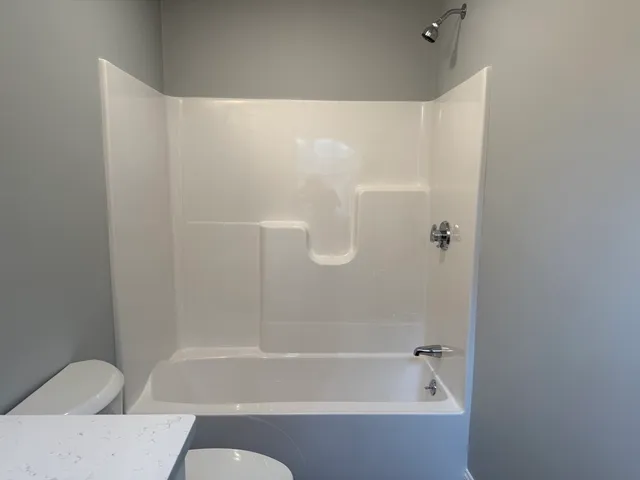 a bathroom with a bathtub and shower