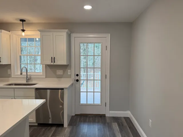 a kitchen with a sink a window and cabinets