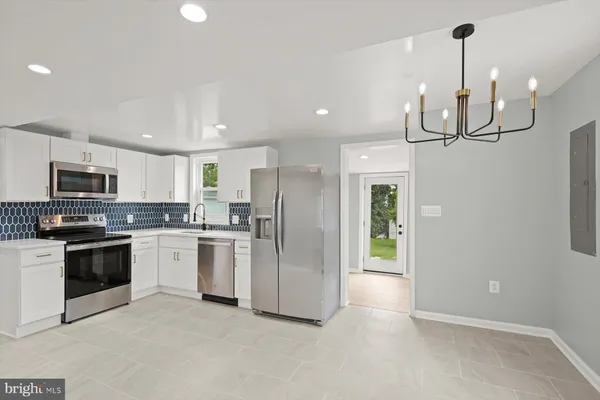 a kitchen with refrigerator and microwave