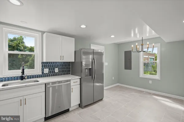 a kitchen with a sink and refrigerator