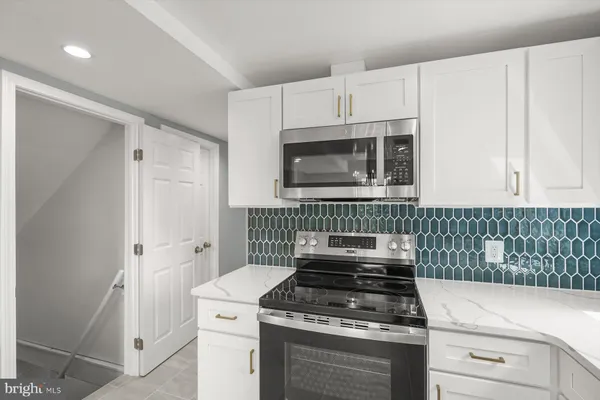 a kitchen with a stove and a microwave