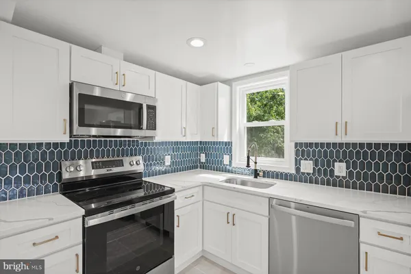 a kitchen with a sink stove and microwave