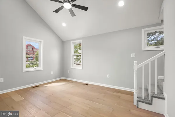 a view of an empty room and wooden floor