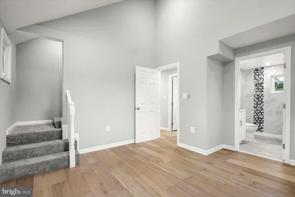 a bathroom with a sink a toilet a vanity and shower