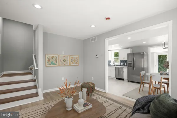a living room with furniture and kitchen view