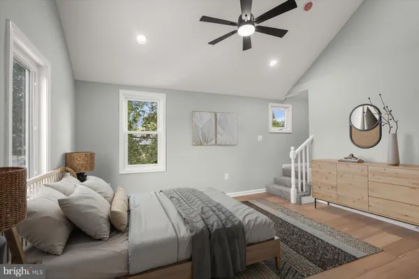 a bedroom with a bed and dresser with mirror