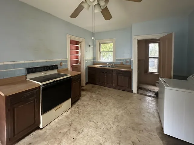 a kitchen with a stove and a refrigerator