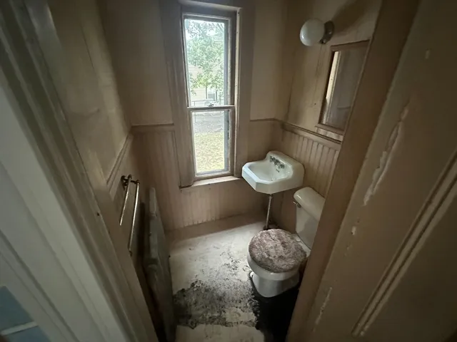 a view of bathroom with a sink and a mirror